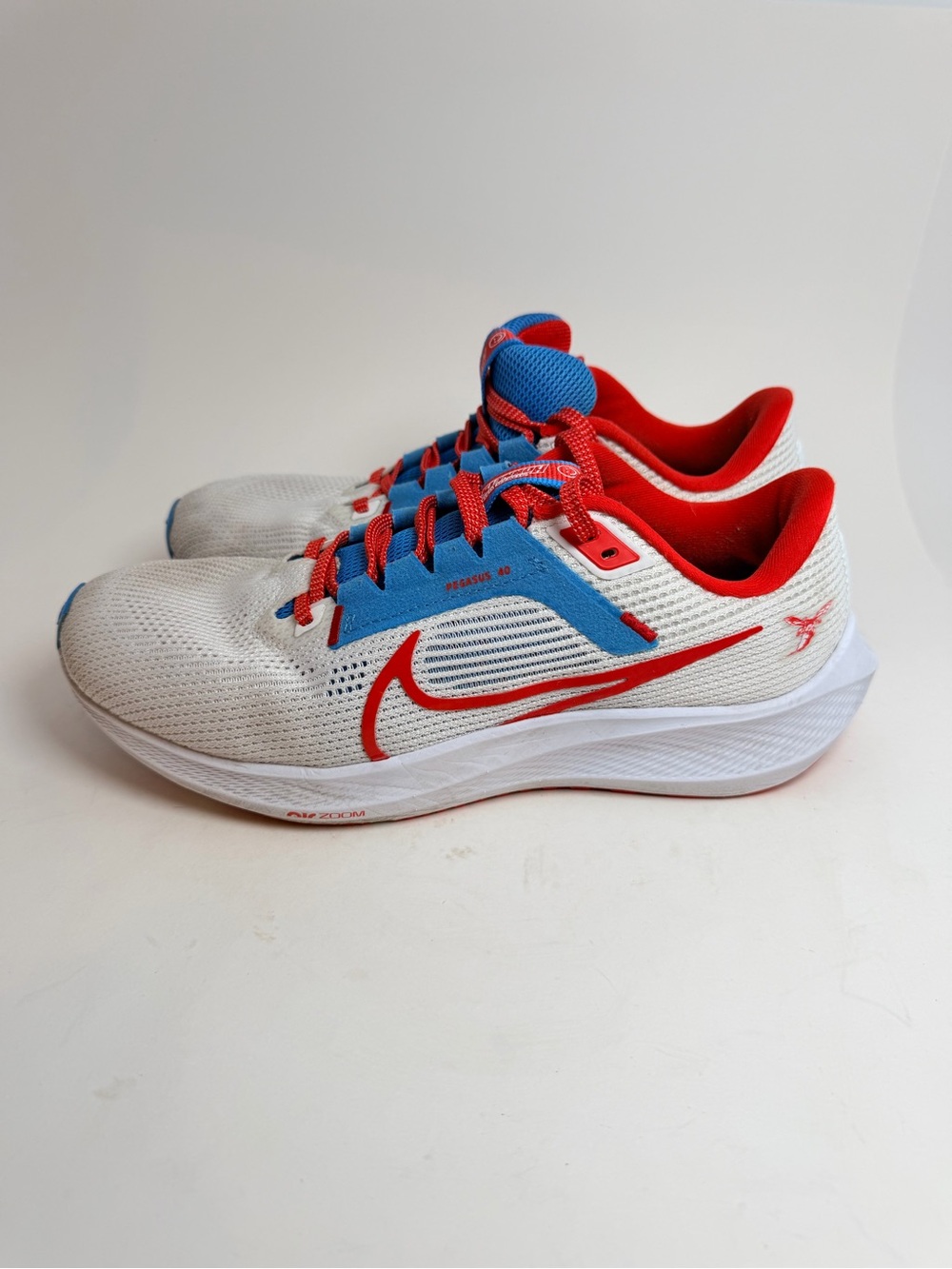Nike White Sneakers with Red Swoosh and Blue Accents